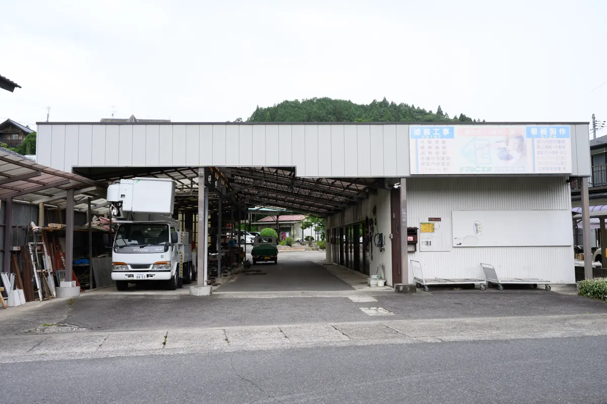 福島県石川町の有限会社マルニ工芸の会社外観と自社保有の高所作業車
