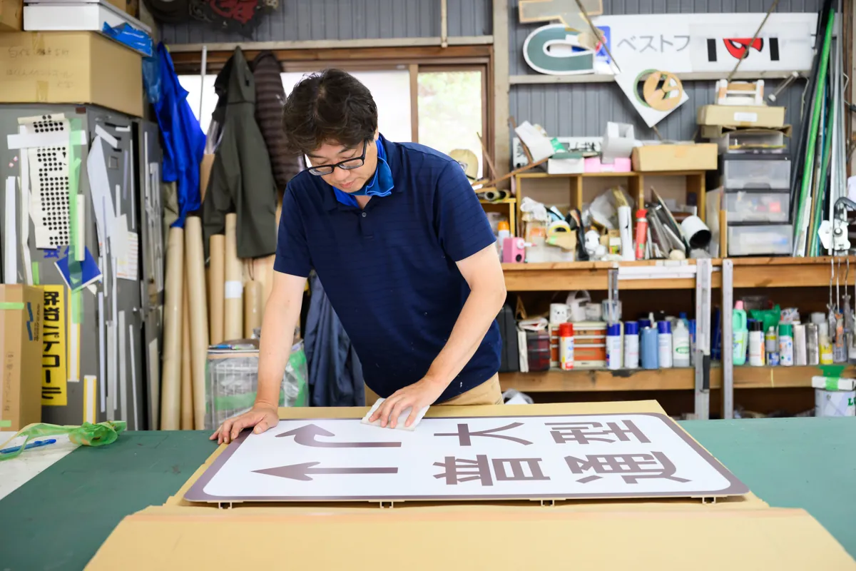 自社工房で道路案内標識を製作する有限会社マルニ工芸の職人